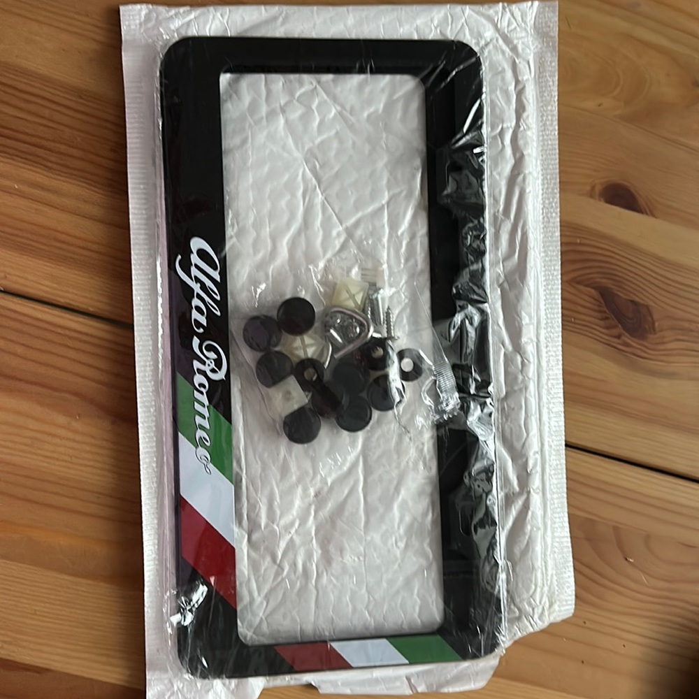 Brand new ALFA ROMEO plates holders front and back included